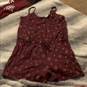 A women’s maroon romper